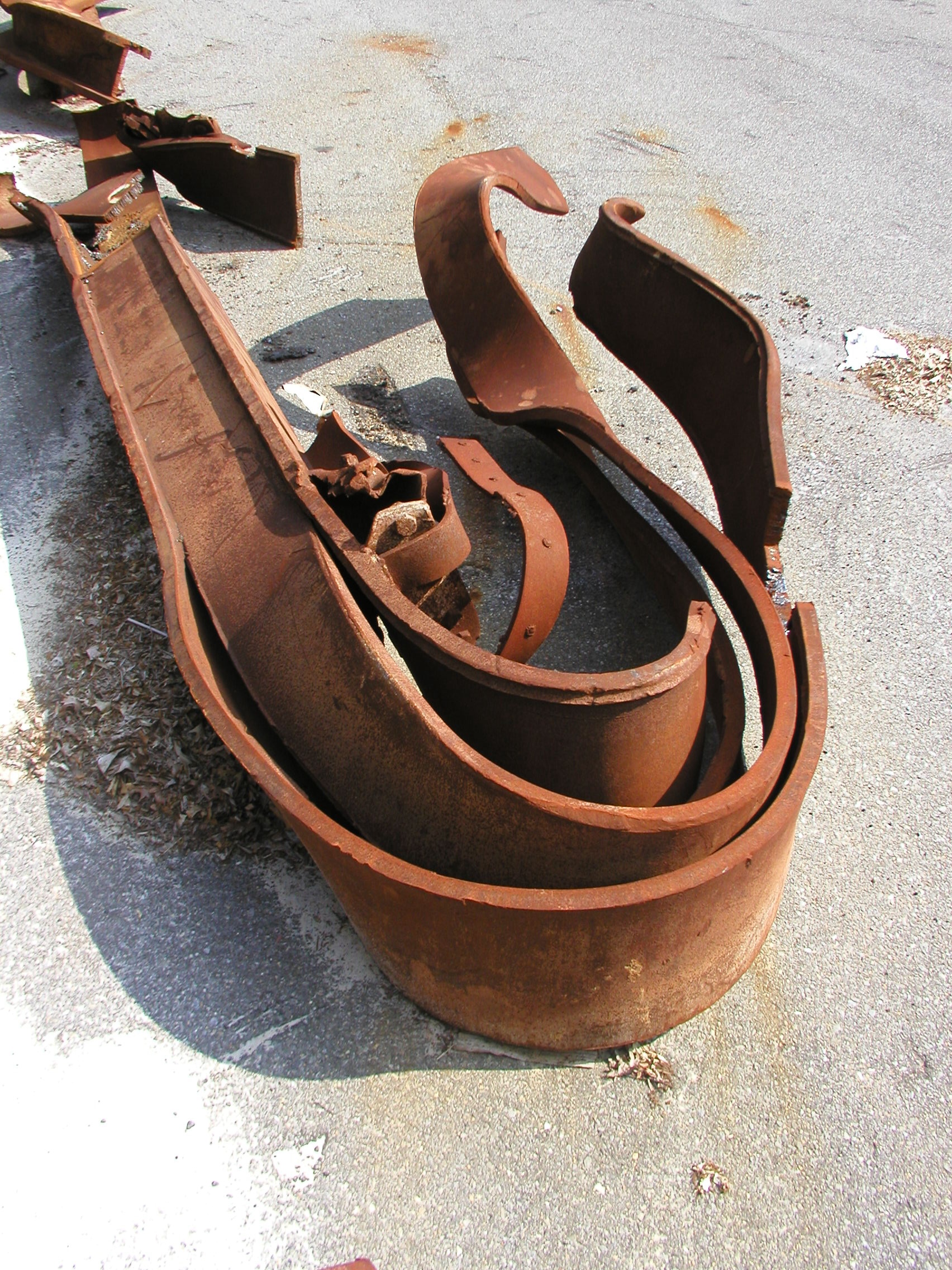 Figure 42. WTC I-Beams Bent around the wrong axis. Monolithic steel column exhibiting smooth upward curl along its length, similar to bimetallic strip, demonstrating differential strain.
  <br>
  - Image by NIST.